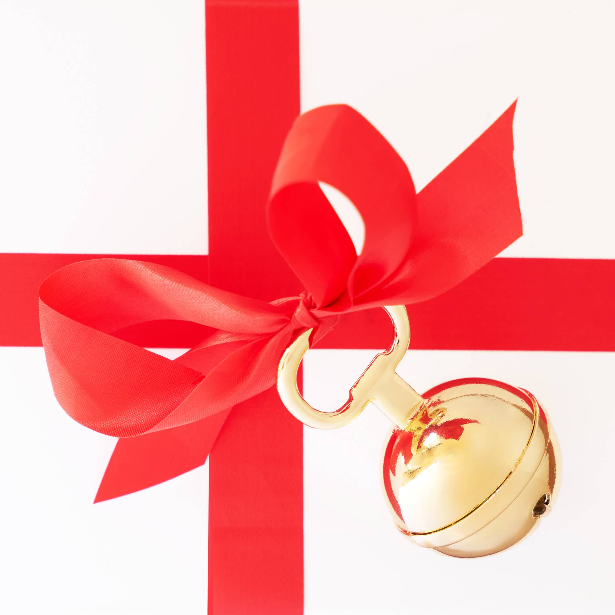 Gold-plated metal jingle bell beer bottle opener with ribbon, a festive kitchen gadget by Twine.