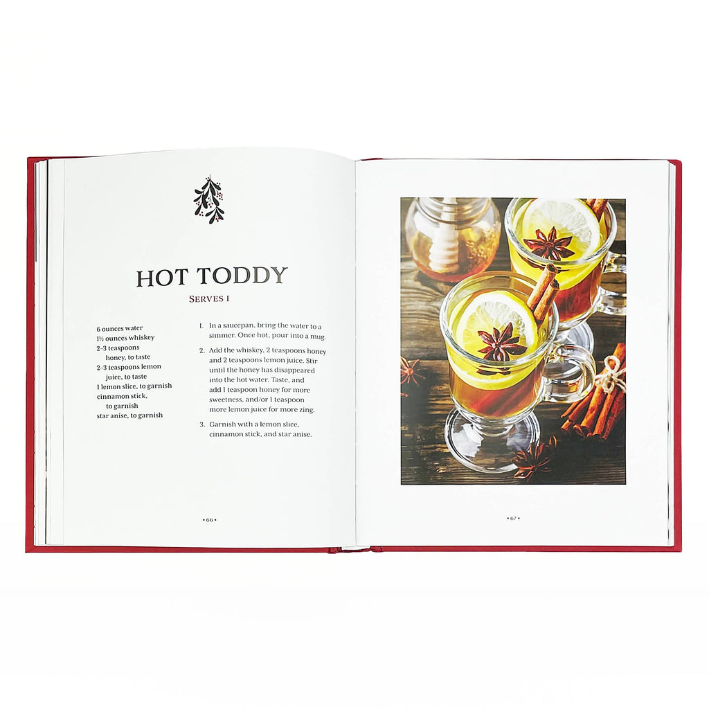 Open book titled "Art of Mixology: Making Spirits Bright Christmas Cocktails" from Cottage Door Press, showing colorful cocktail recipes.