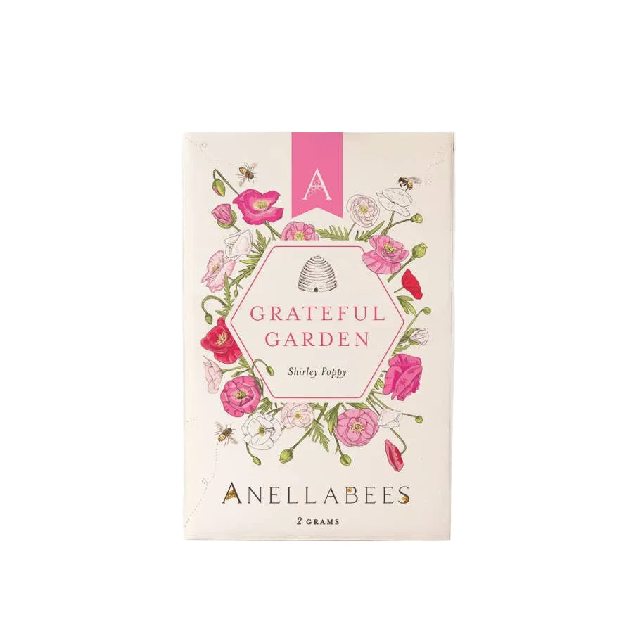 Shirley Poppy flower garden seeds by Anellabees, showing vibrant red poppy flowers blooming in a garden setting.