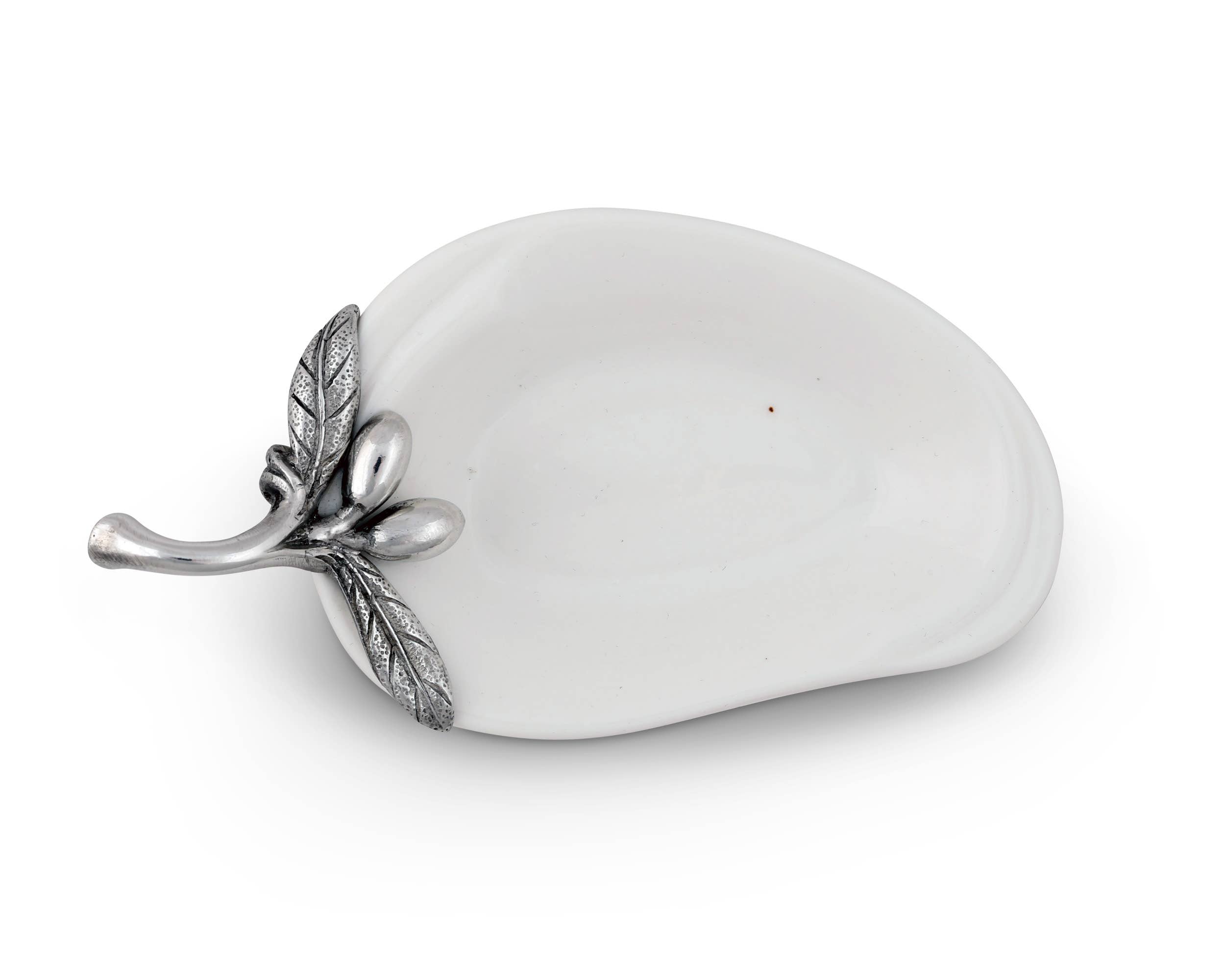 Vagabond House olive oil server for charcuterie, featuring a decorative dish with intricate metalwork and a small olive oil bottle.