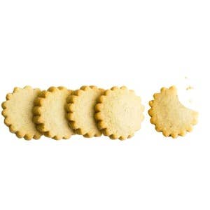 Rustic Bakery vanilla bean shortbread cookies arranged on a plate with visible vanilla bean specks and golden-brown edges.