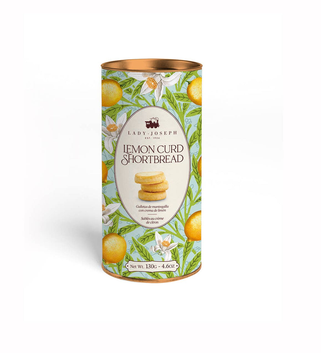 Lady Joseph Lemon Curd Shortbread Cookies on a white plate with lemon slices, showcasing golden-brown, crumbly cookies.