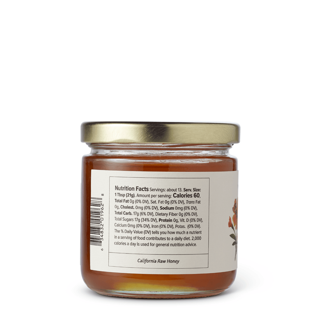 Jar of McEvoy Ranch Orange Blossom Honey with a golden color and floral label, showcasing a natural honey condiment.