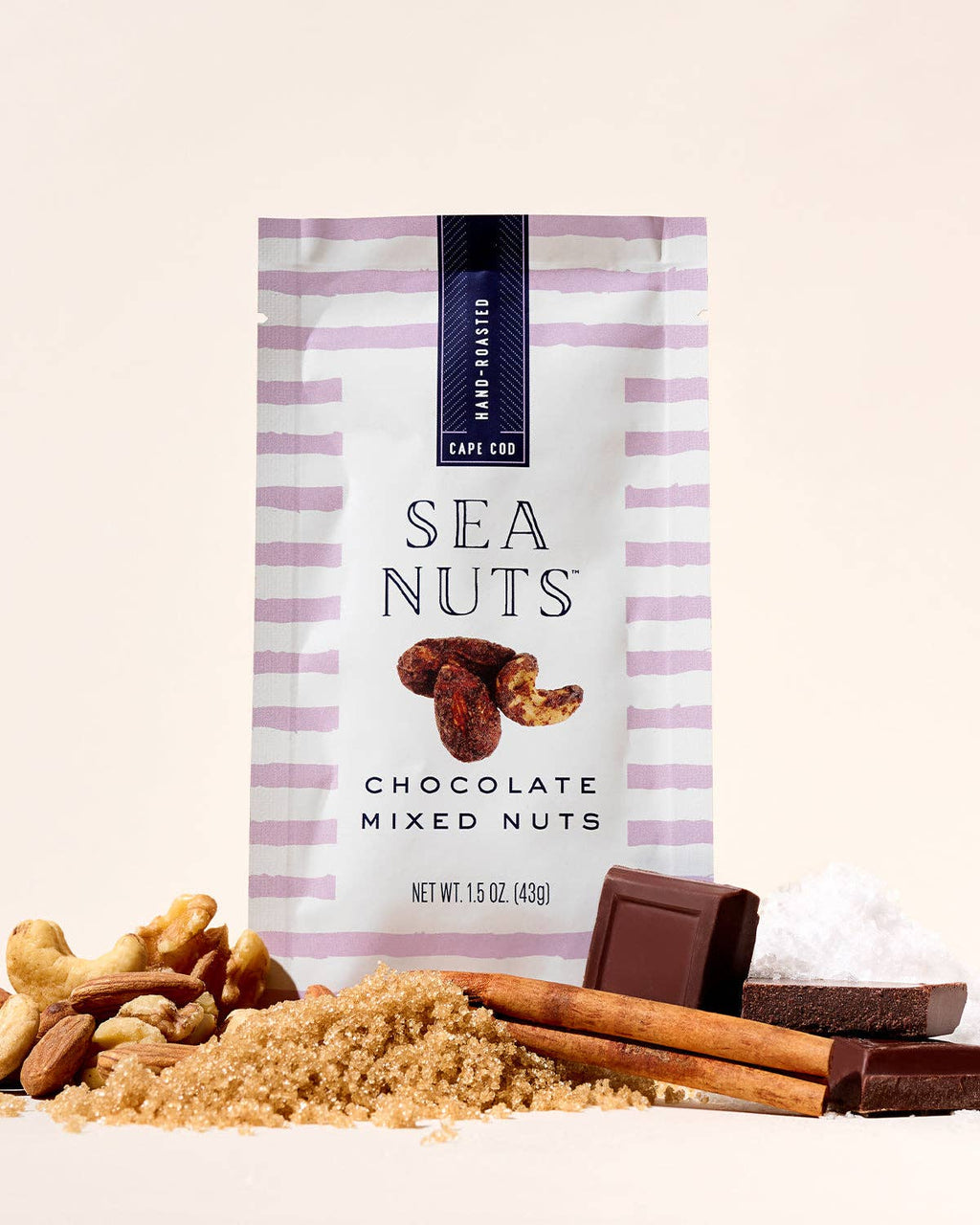 Sea Nuts chocolate mixed nuts in a clear bowl, showing a variety of coated nuts and chocolate pieces.