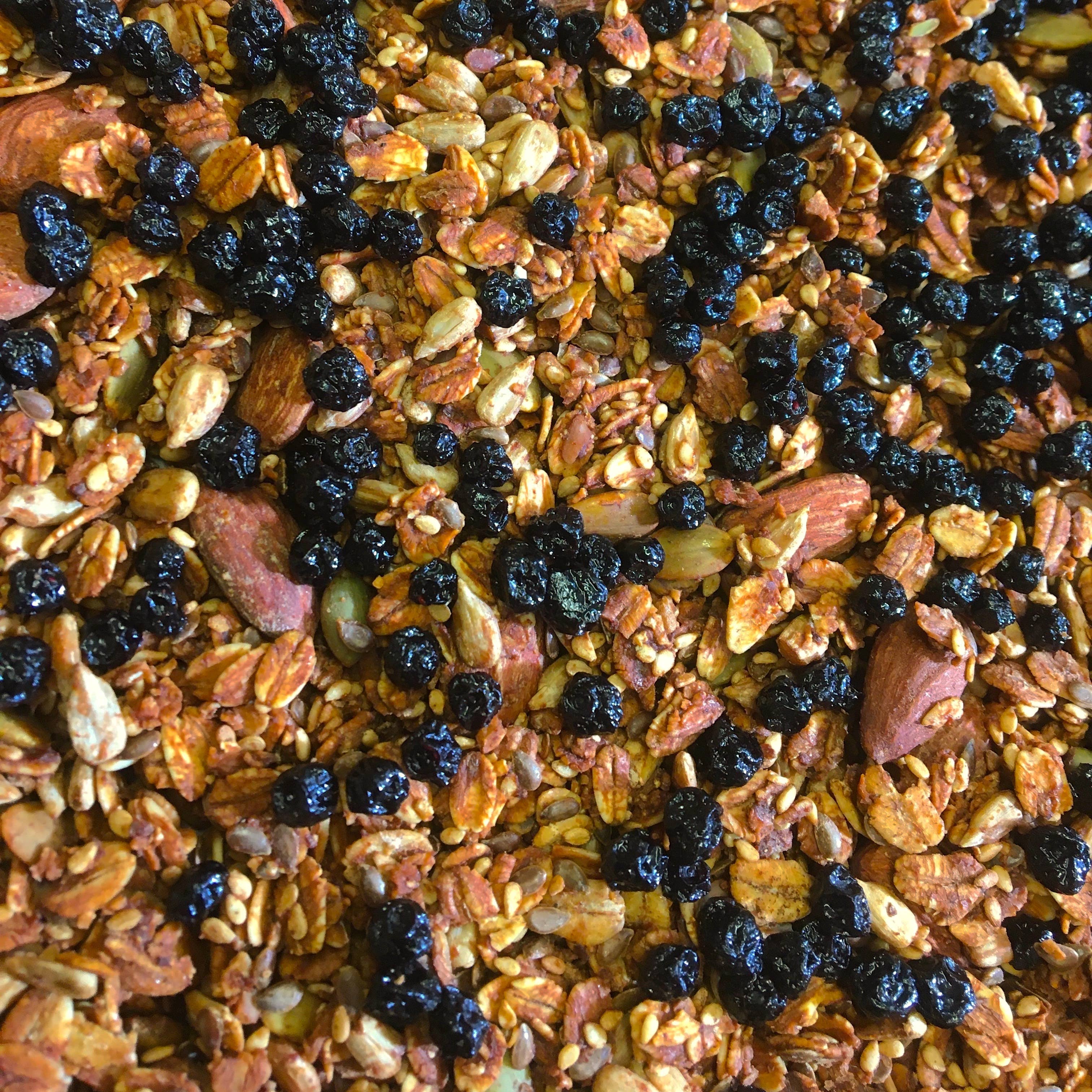 Potters Table Hearts Content Granola snack in a clear bowl, showing a crunchy, heart-shaped granola pieces with mixed grains and nuts.