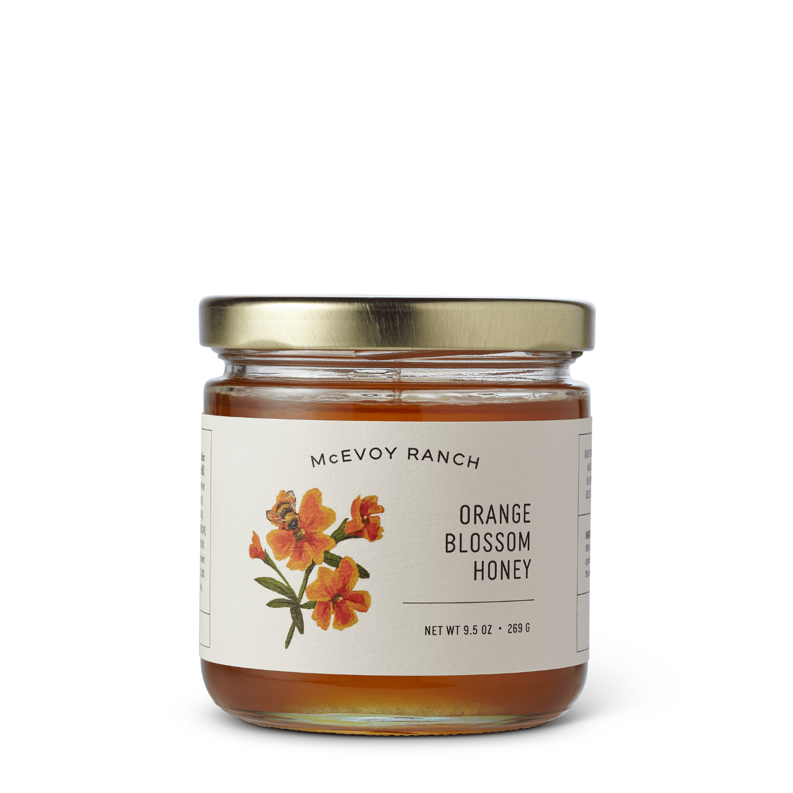 Jar of McEvoy Ranch Orange Blossom Honey, a condiment with golden honey and orange blossom aroma in a glass jar.