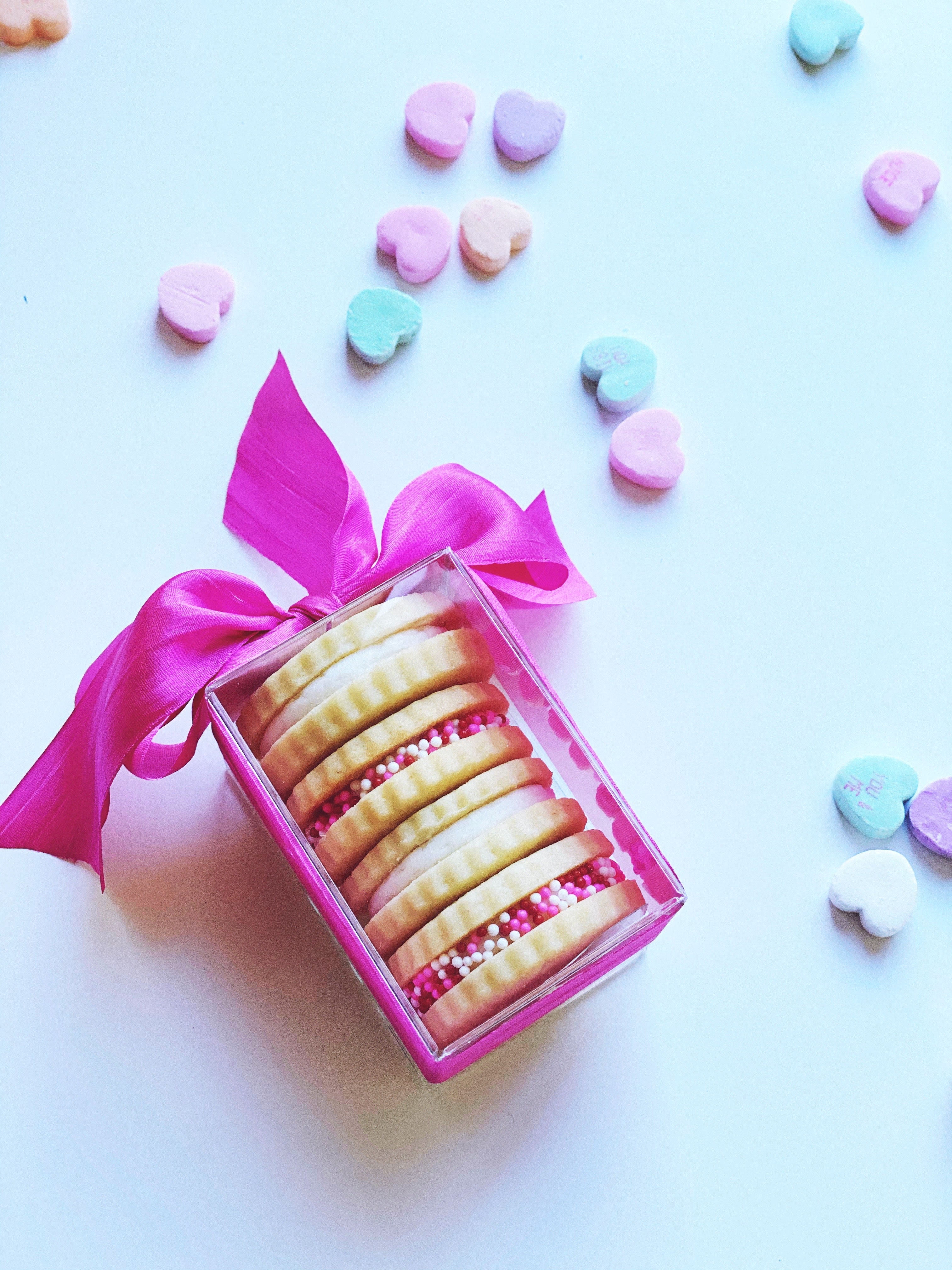 Poppins & Post buttercream sandwich cookies displayed in four boxes, showing creamy filling and cookie exterior.