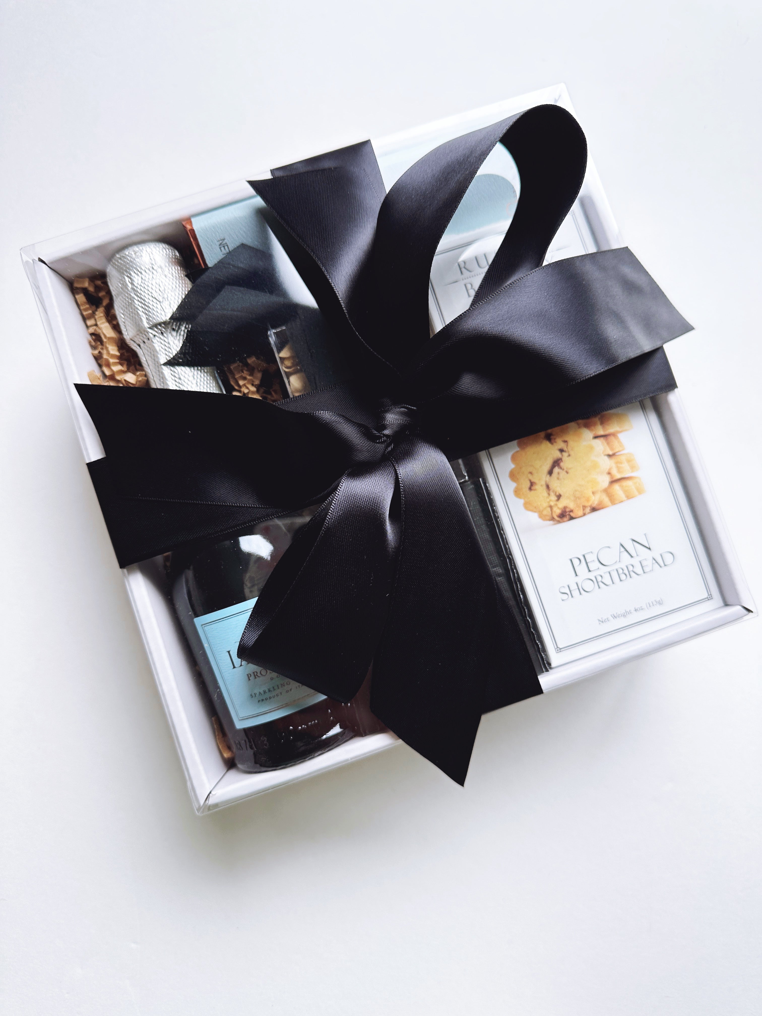 Set of 16 Mon Petit Prosecco welcome gifts and favors by Poppins & Post, featuring small bottles with festive labels.
