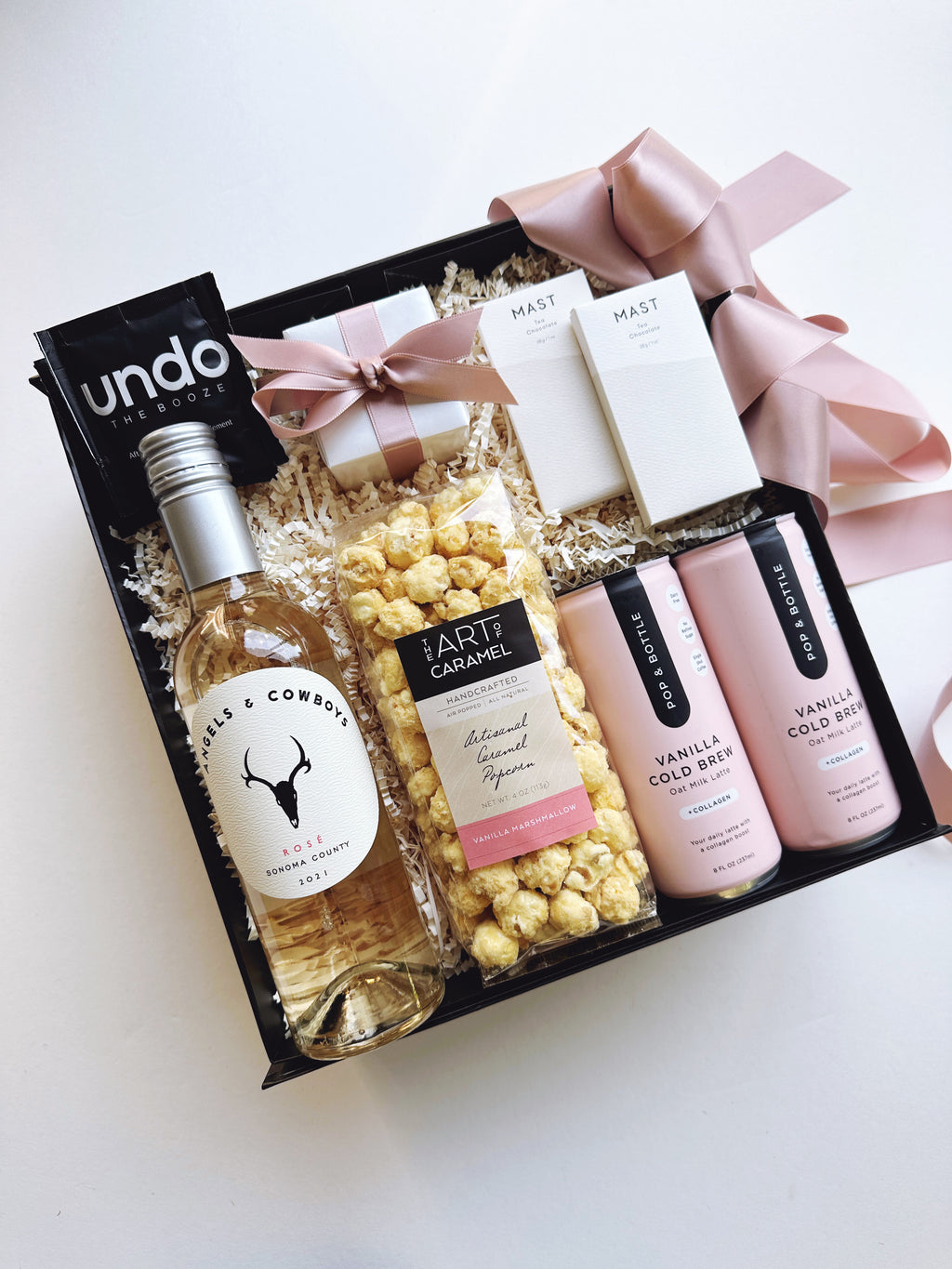 Set of 24 Pretty in Pink gift boxes and tins by Poppins & Post, featuring elegant pink packaging and lid designs.