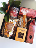 Fall Hostess gift box from Poppins & Post featuring autumn-themed packaging and assorted treats inside.