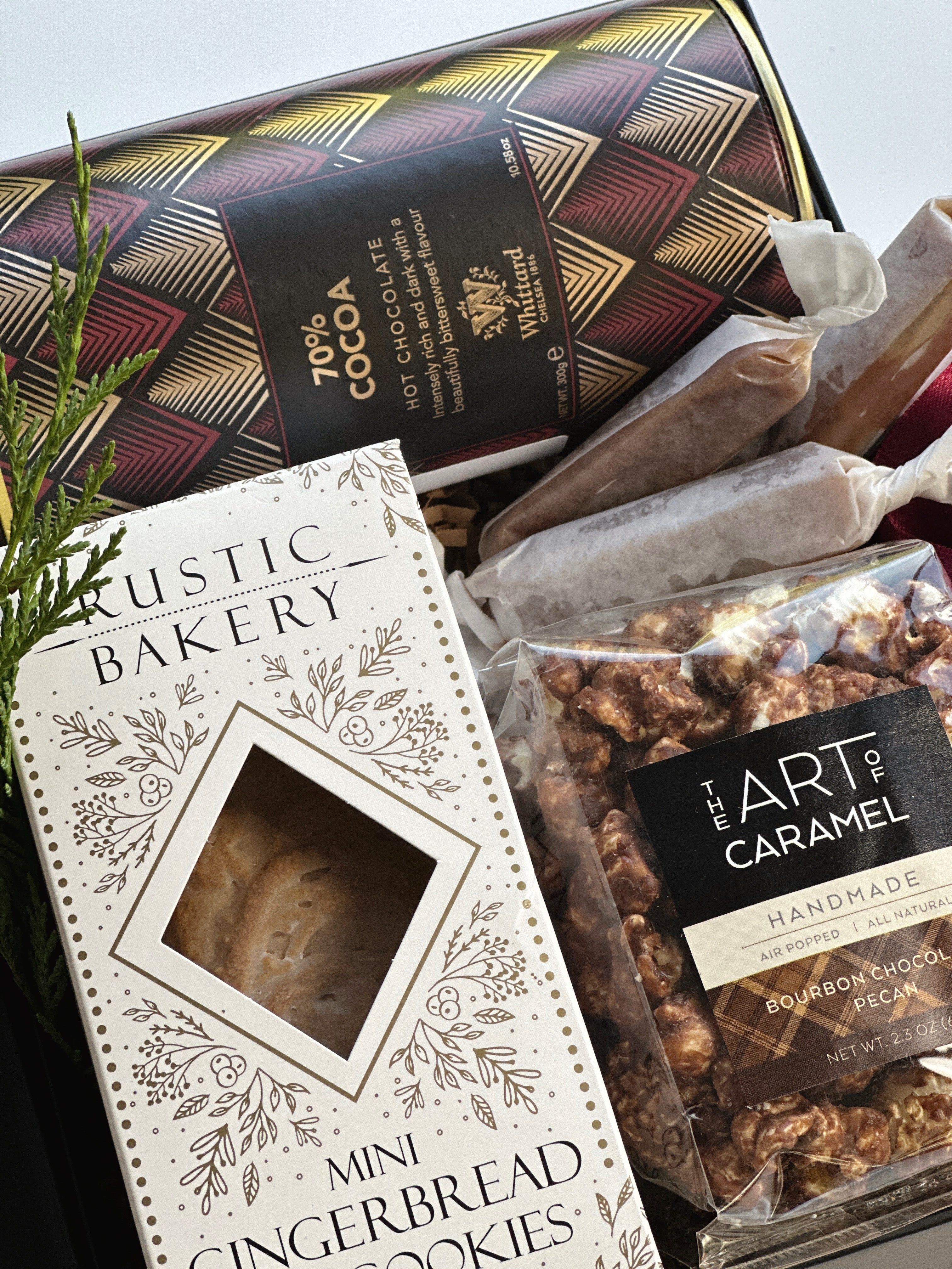 Gift box of cocoa and cookies by Poppins & Post, featuring assorted chocolates and baked treats in an elegant packaging.