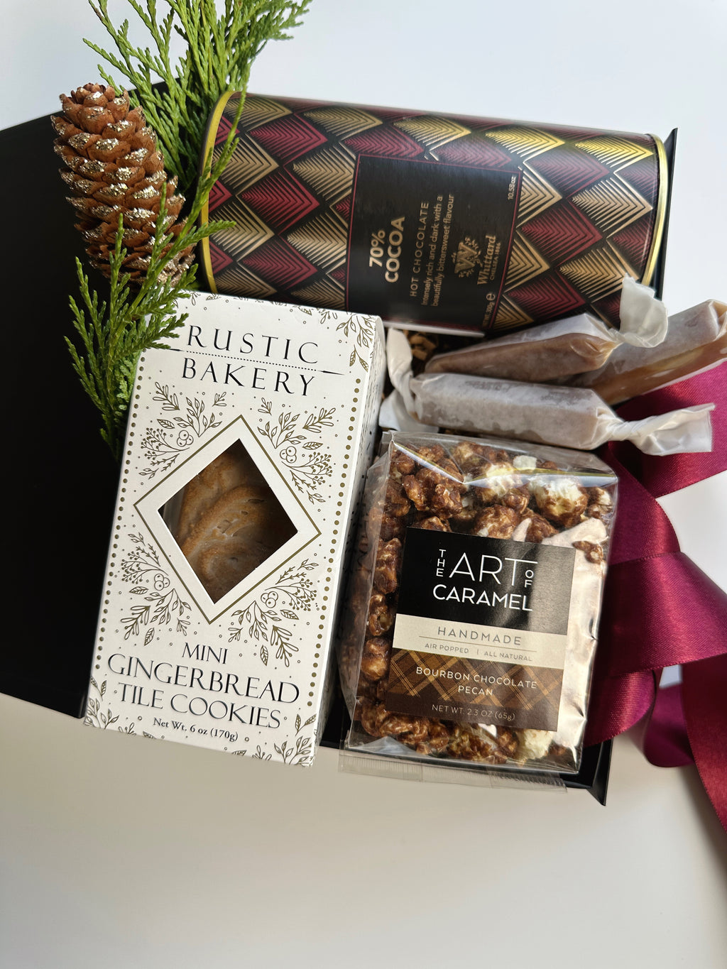 Gift box of cocoa and cookies from Poppins & Post featuring assorted chocolates and baked treats in a decorative packaging.