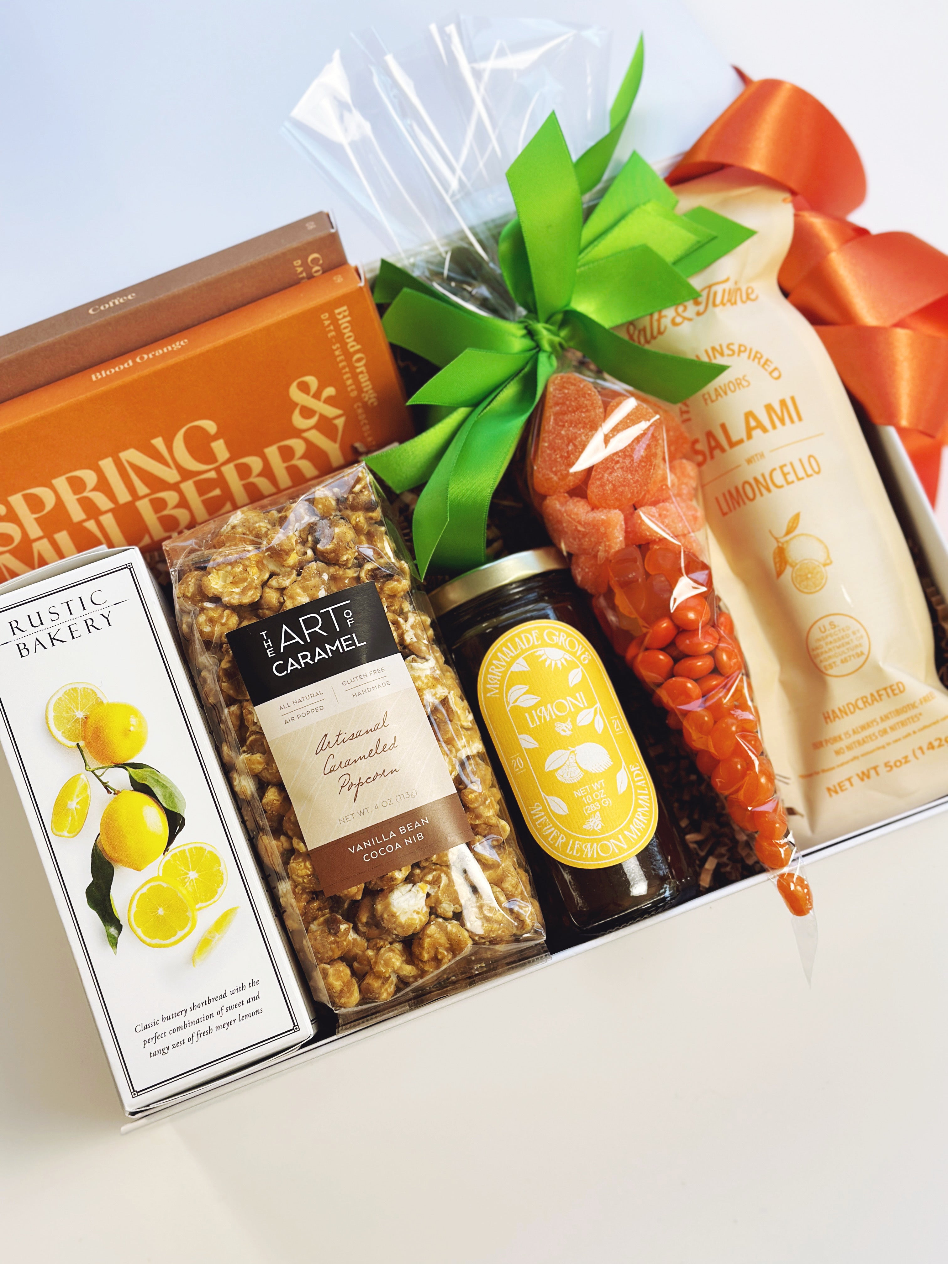 Spring Citrus gift box from Poppins & Post with colorful citrus-themed packaging and assorted citrus treats inside.