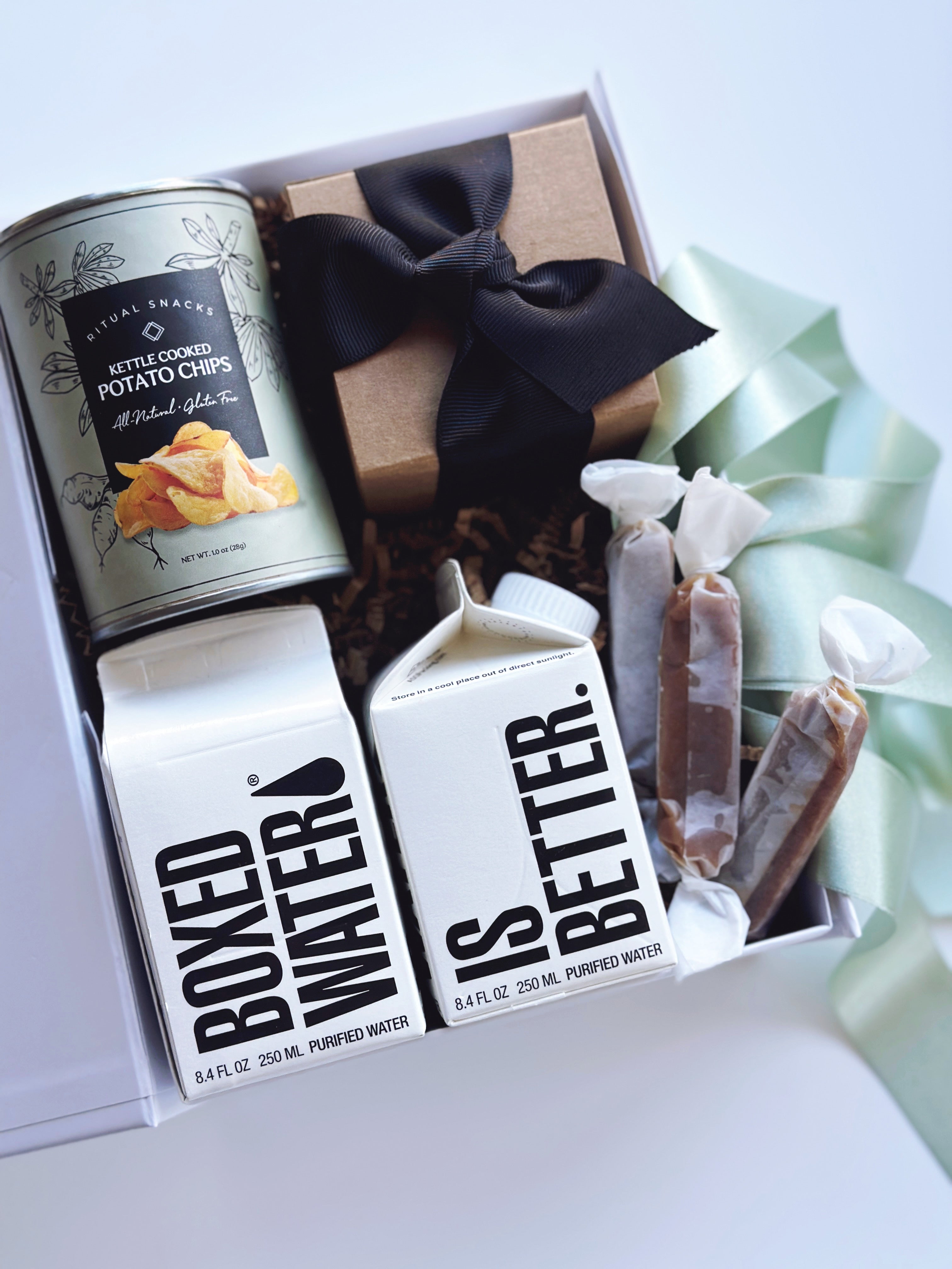 Sweet and salty wedding welcome gift set by Poppins & Post, featuring assorted treats in a decorative box for guests.