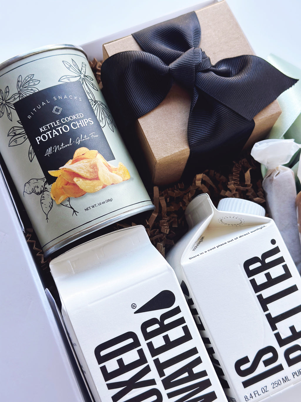 Sweet and salty wedding welcome gift box by Poppins & Post, featuring assorted treats for guests.