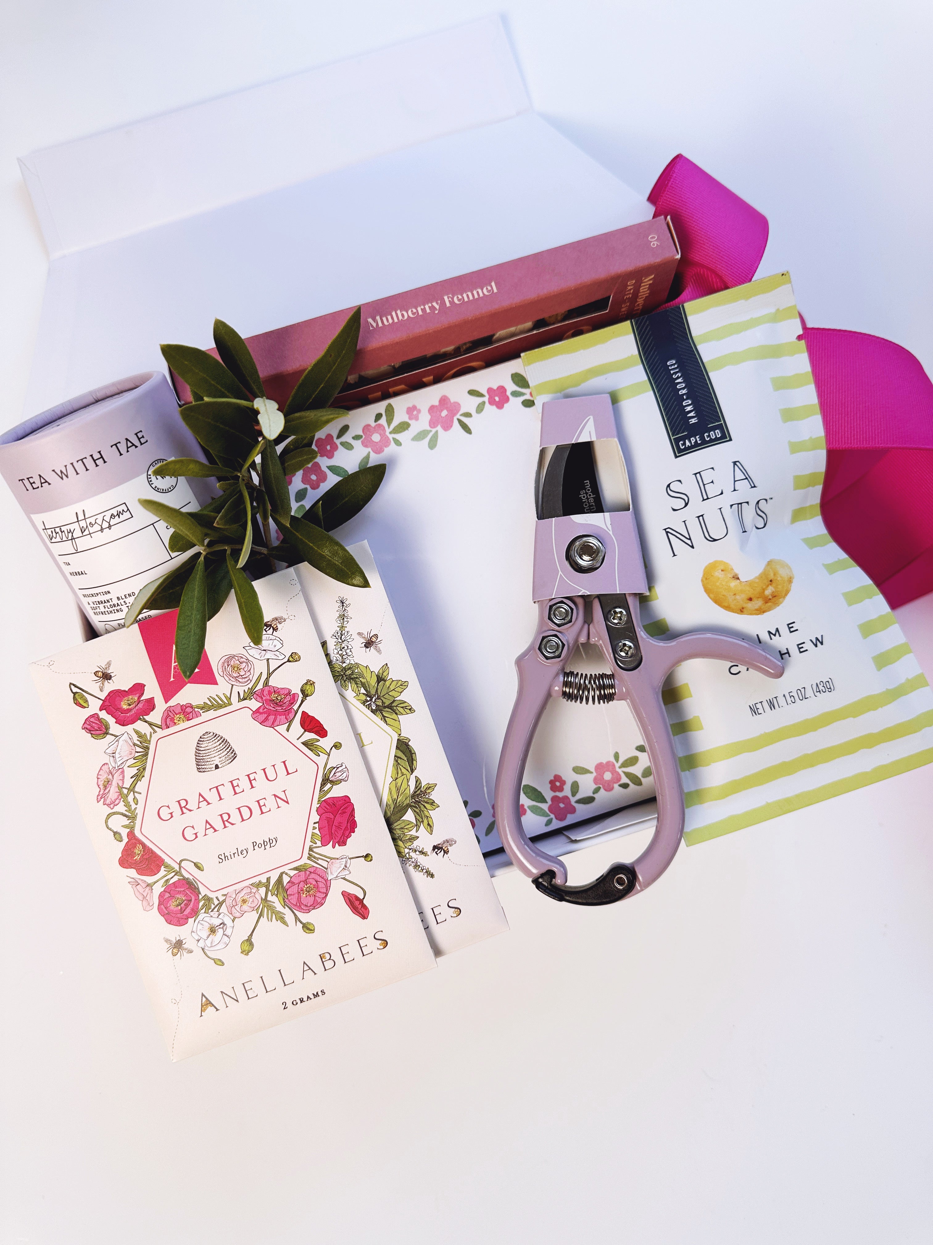 Poppins & Post Gardener's Gift Box with gardening tools, gloves, and plant seeds arranged in a decorative gift box.