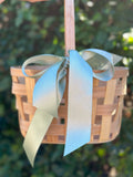 Small gift basket from Poppins & Post filled with assorted treats and decorative wrapping, perfect for gifting occasions.