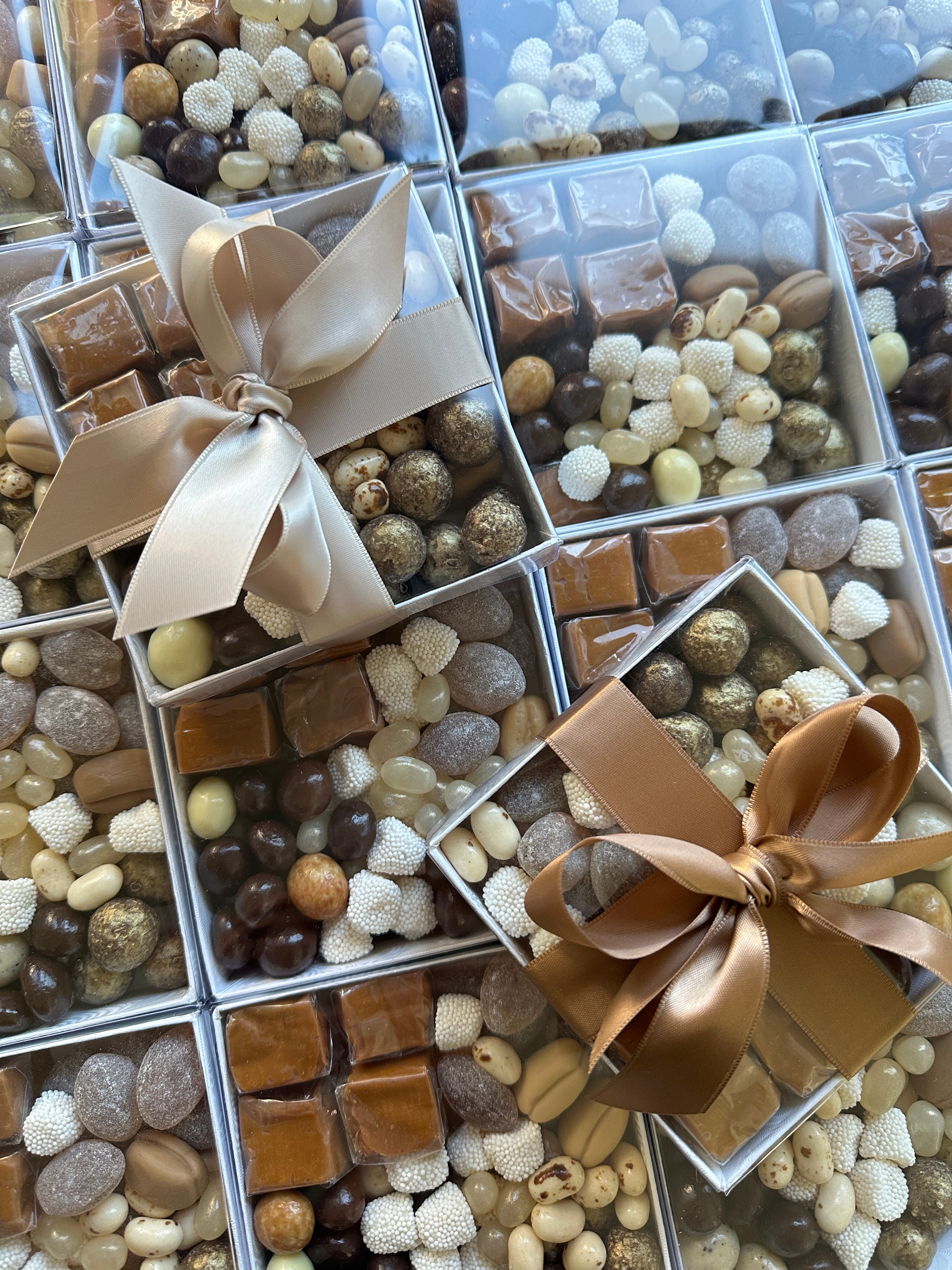 Set of 24 custom Poppins & Post chocolate and candy boxes with colorful designs for gift packaging or party favors.
