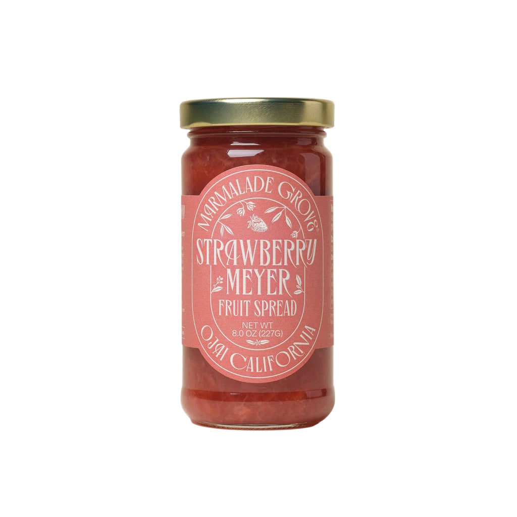 Jar of strawberry meyer fruit spread with a pink label on a white background by Marmalade Grove in Ojai California.
