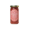 Jar of strawberry meyer fruit spread with a pink label on a white background by Marmalade Grove in Ojai California.