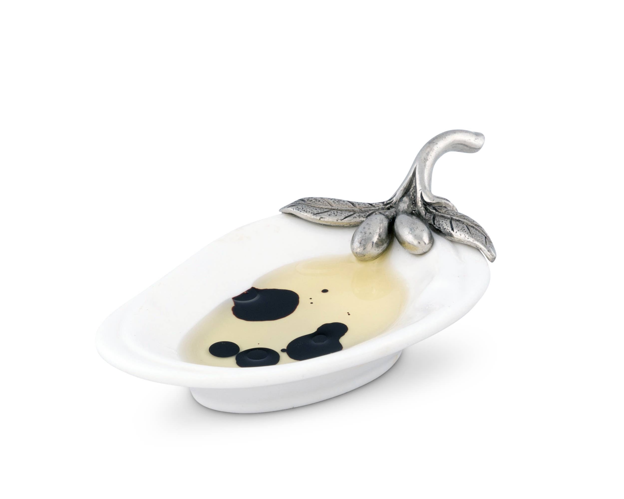 Vagabond House olive oil server for charcuterie, featuring elegant metal design and a small dish for oil or condiments.