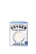 White Sonora pancake mix from Hayden Flour Mills, shown in a bag with fresh ingredients and a prepared pancake on a plate.