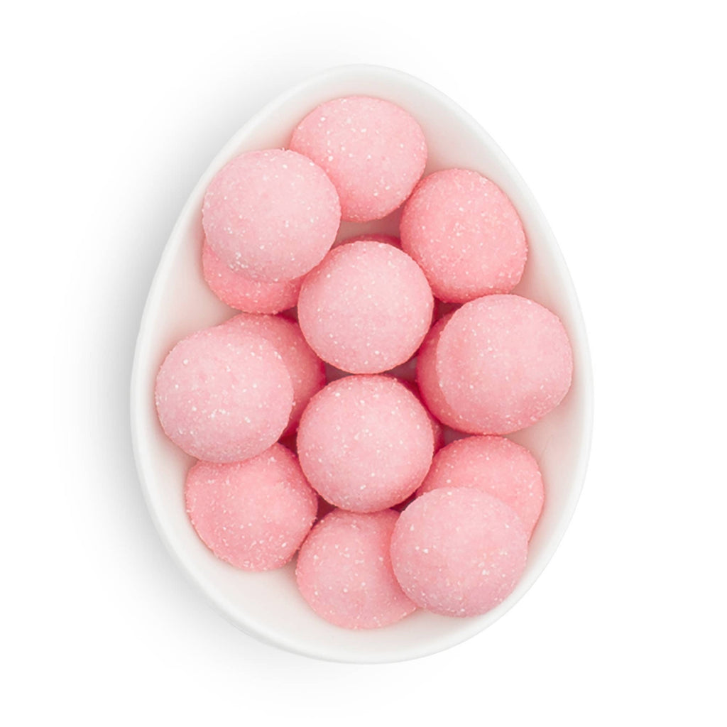 Small pink Sugarfina candy bonbons, colorful chocolate and candy treats in a clear container, perfect for sweet indulgence.