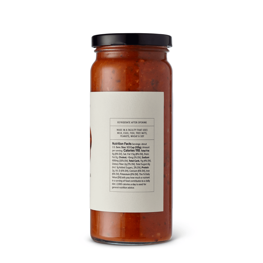 Jar of McEvoy Ranch Basil and Pine Nut Pomodoro Sauce, a 16 oz pantry staple with fresh basil and pine nuts in a glass jar.