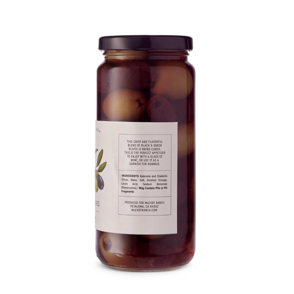 Unpitted McEvoy Ranch Table Olives in 8.5 oz jar, showcasing glossy green olives in a clear glass container.