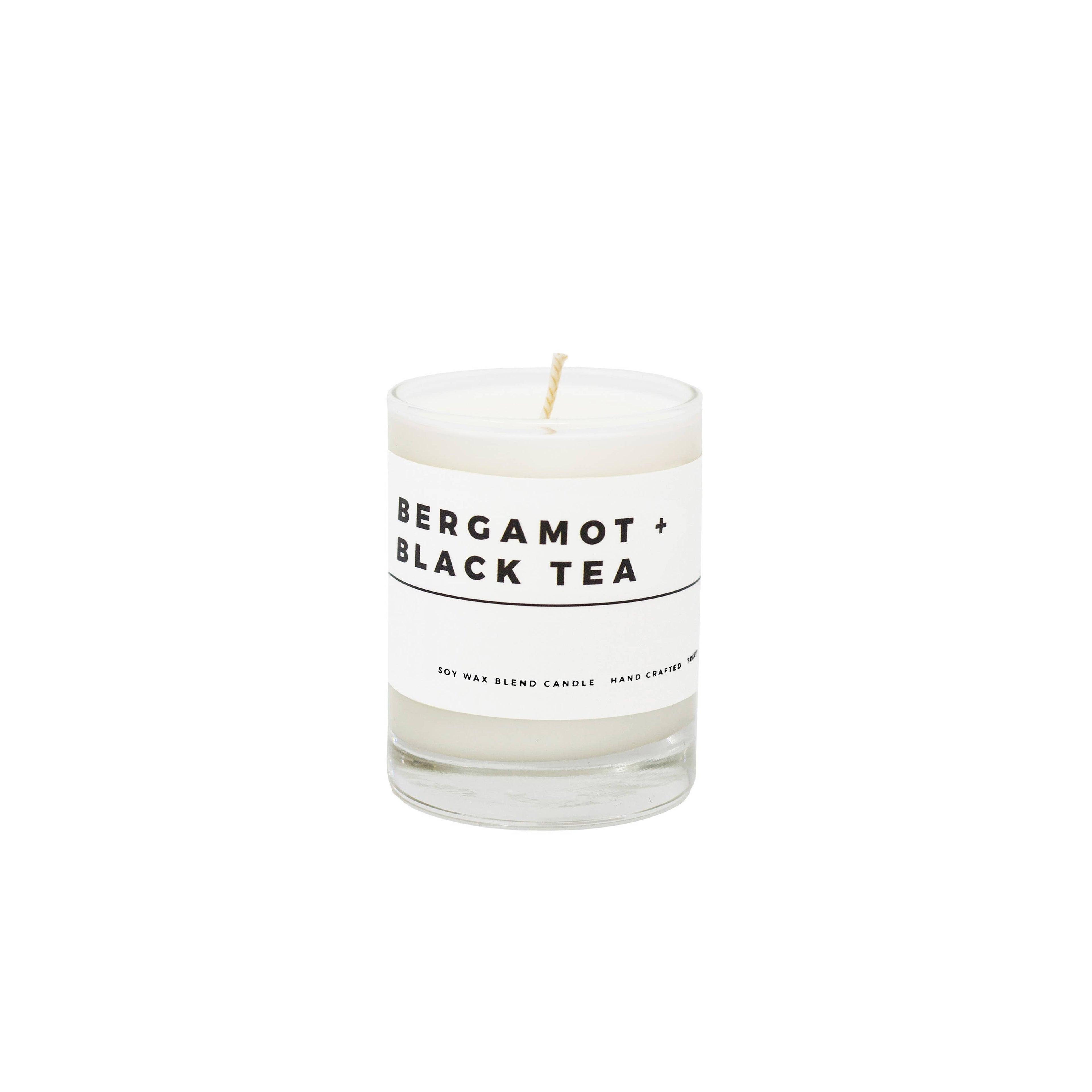 True Hue Bergamot and Black Tea Mini Candle with a sleek glass holder, featuring a warm, inviting flame.