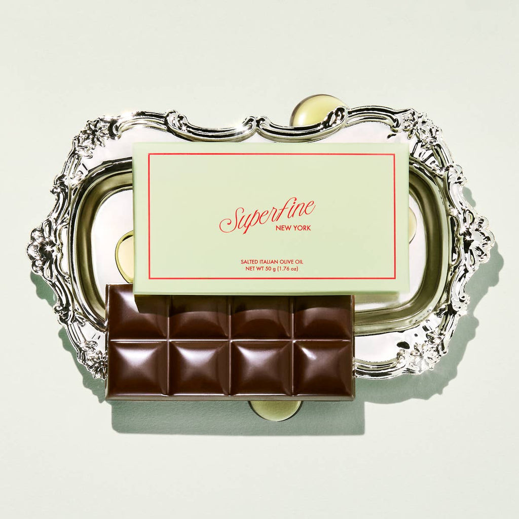 Superfine Chocolate Salted Italian Olive Oil Bar featuring dark chocolate with a salted olive oil filling, displayed on a white plate.