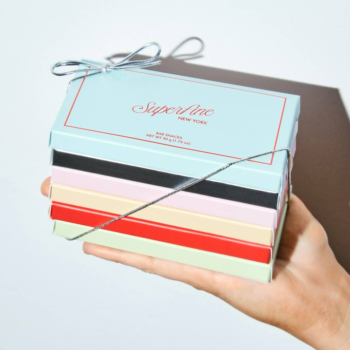 Superfine Chocolate Meyer Lemon Poppyseed Bar with lemon zest and poppy seeds on a chocolate base, showcasing a textured surface.